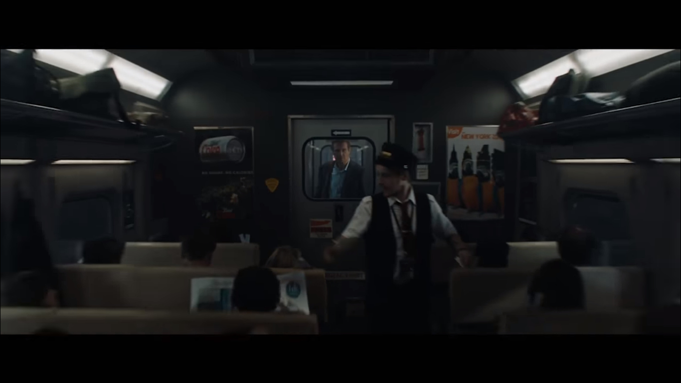 Liam Neeson at far end of train in The Commuter