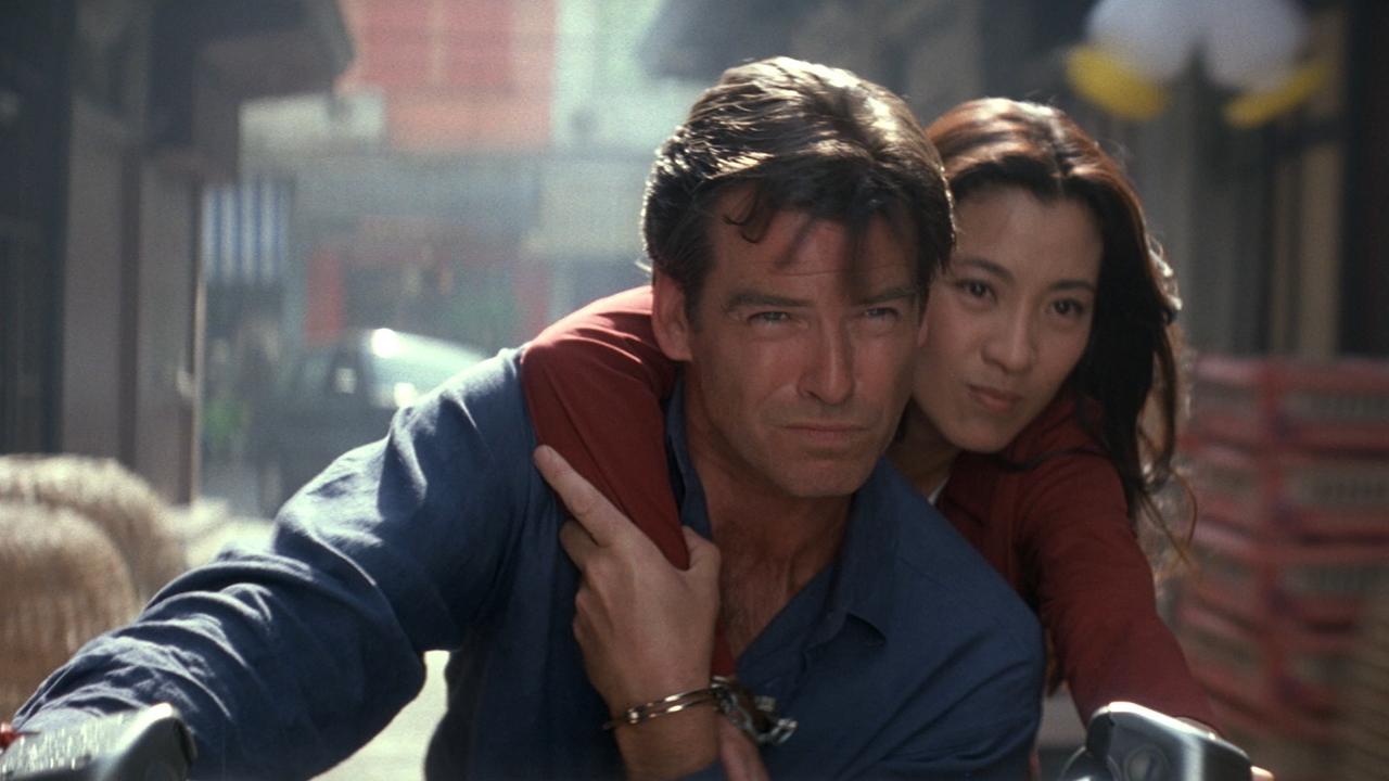Pierce Brosnan as James Bond with Michelle Yeoh on motorcycle in Tomorrow Never Dies