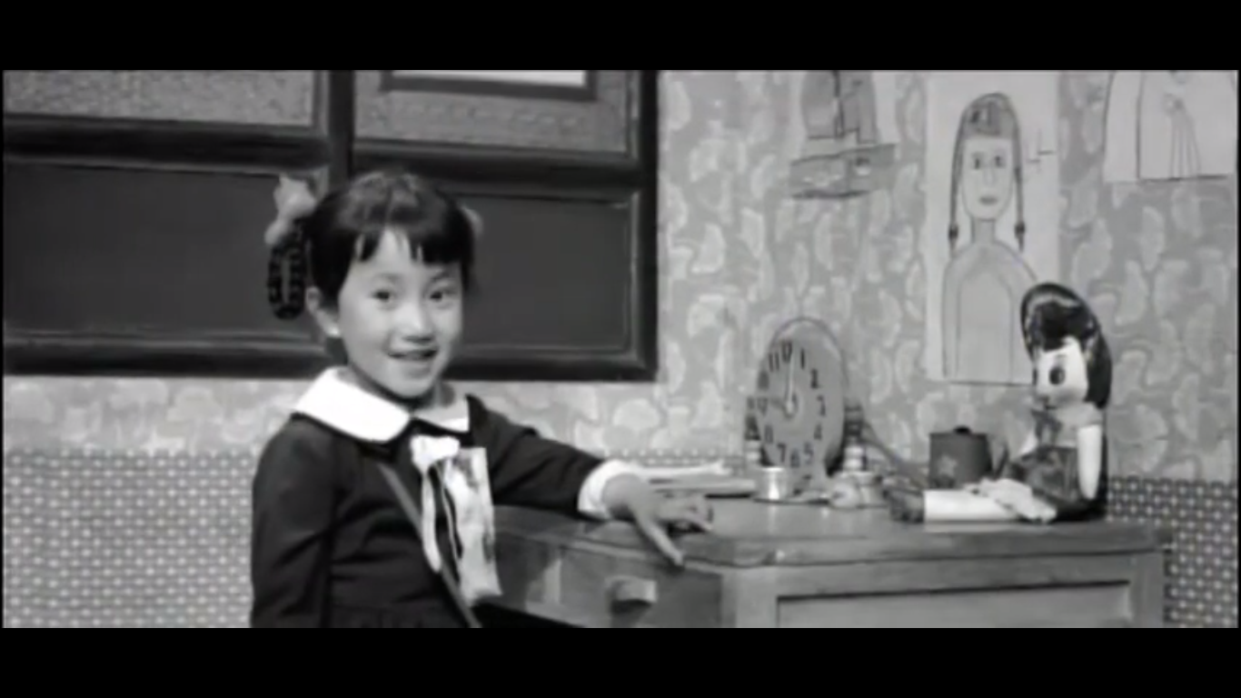 Image of Ok-hee at her desk in My Mother and Her Guest Image of Ok-hee at her desk